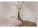 Bedroom with wood floors, ensuite bathroom and closet with sliding doors at 3128 E Tina Dr, Phoenix, AZ 85050