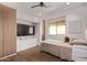 Modern bedroom featuring built-in storage, a ceiling fan, and a cozy window view at 3128 E Tina Dr, Phoenix, AZ 85050