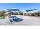 Community amenities featuring an outdoor seating area with shade and playground in the background at 3128 E Tina Dr, Phoenix, AZ 85050