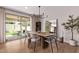 Elegant dining room with modern chandelier, large mirror, and sliding glass doors to the patio at 3128 E Tina Dr, Phoenix, AZ 85050