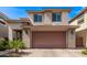 Attractive two-story home featuring a two-car garage, desert landscaping, and a welcoming entrance at 3128 E Tina Dr, Phoenix, AZ 85050