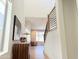 Bright hallway leads to living room with wood floors and modern staircase design at 3128 E Tina Dr, Phoenix, AZ 85050