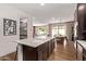 Modern kitchen with quartz counters, dark cabinets, and seamless flow to dining area at 3128 E Tina Dr, Phoenix, AZ 85050