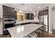 Spacious kitchen features dark cabinets, stainless appliances, and large center island at 3128 E Tina Dr, Phoenix, AZ 85050