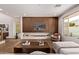 Bright living room with a striking wood accent wall, fireplace, and modern furnishings at 3128 E Tina Dr, Phoenix, AZ 85050