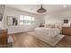 Sunlit main bedroom with a large window, elegant decor, and hardwood flooring at 3128 E Tina Dr, Phoenix, AZ 85050