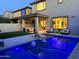 Backyard pool with travertine tile, lounge chairs, and covered patio seating area at 3128 E Tina Dr, Phoenix, AZ 85050