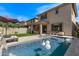 Beautiful backyard pool with a waterfall feature, lounge chairs, and a covered patio area at 3128 E Tina Dr, Phoenix, AZ 85050