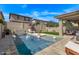 Backyard pool oasis with water feature, lounge chairs, and lush landscaping at 3128 E Tina Dr, Phoenix, AZ 85050