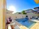 Inviting backyard pool area with travertine tile, lounge chairs, and floating swan decorations at 3128 E Tina Dr, Phoenix, AZ 85050
