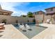 Backyard swimming pool with waterfall feature, accented with modern swan floats at 3128 E Tina Dr, Phoenix, AZ 85050