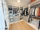Organized walk-in closet with custom shelving and ample storage space for clothing at 3128 E Tina Dr, Phoenix, AZ 85050