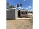 View of exterior including a covered patio area and palm trees in the background at 318 N 83Rd Pl, Mesa, AZ 85207