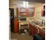 Functional kitchen with wooden cabinets, appliances, and visible sink at 318 N 83Rd Pl, Mesa, AZ 85207