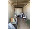 Unfinished room featuring a table, chair, washing machine and other storage containers at 318 N 83Rd Pl, Mesa, AZ 85207