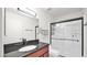 A modern bathroom with a dark countertop, glass-enclosed shower, and updated fixtures at 3345 E University Dr # 47, Mesa, AZ 85213