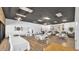 Spacious community room with tables, seating, wood floors, and natural light at 3345 E University Dr # 47, Mesa, AZ 85213