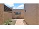 View of a home featuring a bench in an exterior courtyard with desert landscaping at 3345 E University Dr # 47, Mesa, AZ 85213