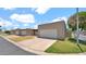 Street view of townhomes featuring attached garages, well-maintained lawns, and desert landscaping at 3345 E University Dr # 47, Mesa, AZ 85213