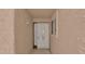 Up close view of a tan stucco entryway featuring a security door and window at 3345 E University Dr # 47, Mesa, AZ 85213