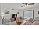 Cozy living room with tile flooring, ceiling fan, and view to outdoor patio at 3345 E University Dr # 47, Mesa, AZ 85213