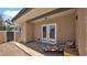 Covered back patio with brick pavers, neutral stucco and sliding doors at 3345 E University Dr # 47, Mesa, AZ 85213