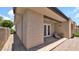 Stucco patio with brick pavers and outdoor chair by the back doors at 3345 E University Dr # 47, Mesa, AZ 85213