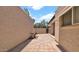 Brick patio with view of gated walkway, mature trees, and a bird bath at 3345 E University Dr # 47, Mesa, AZ 85213