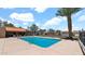 Community pool with palm trees and lounge chairs under a sunny sky at 3345 E University Dr # 47, Mesa, AZ 85213