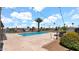 Community pool area featuring string lights, palm tree, patio and lounge chairs against a blue sky at 3345 E University Dr # 47, Mesa, AZ 85213