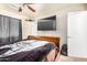 Comfortable bedroom with ceiling fan and large television at 3562 W Seldon Ln, Phoenix, AZ 85051
