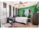 This is a bedroom with green walls, a ceiling fan and carpet at 3562 W Seldon Ln, Phoenix, AZ 85051