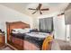 Spacious bedroom featuring a ceiling fan, carpet and large window at 3562 W Seldon Ln, Phoenix, AZ 85051