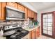 This kitchen has stainless steel appliances, tile backsplash, granite countertops and a double sink at 3562 W Seldon Ln, Phoenix, AZ 85051