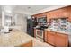 Well-lit kitchen features stainless steel appliances, granite countertops, and wood cabinets at 3562 W Seldon Ln, Phoenix, AZ 85051