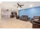 Spacious open-concept living room featuring neutral tile flooring and flexible living spaces at 3562 W Seldon Ln, Phoenix, AZ 85051