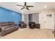 Inviting living room with a blue accent wall, neutral tile flooring, and comfortable seating at 3562 W Seldon Ln, Phoenix, AZ 85051