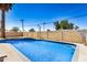 Sparkling in-ground pool with tiled accents and a bright blue sky above at 3562 W Seldon Ln, Phoenix, AZ 85051