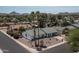 Aerial view of a charming home with desert landscaping, palm trees, and mountain views at 3759 E Charter Oak Rd, Phoenix, AZ 85032