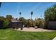 Landscaped backyard featuring greenery, gravel, and a garden, creating a serene and peaceful outdoor space at 3759 E Charter Oak Rd, Phoenix, AZ 85032