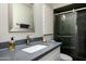 Modern bathroom with sleek vanity, updated mirror, and walk-in shower offering a clean and stylish design at 3759 E Charter Oak Rd, Phoenix, AZ 85032