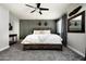 Charming main bedroom boasts an elegant wood bed frame, neutral carpet, and updated fan creating a relaxing ambiance at 3759 E Charter Oak Rd, Phoenix, AZ 85032