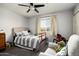 Cozy bedroom features a plush bed, gray walls, and a variety of toys, creating a welcoming and playful space at 3759 E Charter Oak Rd, Phoenix, AZ 85032