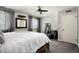 Bright bedroom with a comfortable bed, a cozy armchair, and large windows providing ample natural light and inviting space at 3759 E Charter Oak Rd, Phoenix, AZ 85032