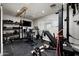 Home gym with weight machines, free weights, punching bag, and fitness bike at 3759 E Charter Oak Rd, Phoenix, AZ 85032
