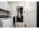 View of hallway featuring laundry machines and a home gym through doorway at 3759 E Charter Oak Rd, Phoenix, AZ 85032