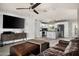 Spacious open floor plan with living room flowing into kitchen with modern ceiling fan at 3759 E Charter Oak Rd, Phoenix, AZ 85032