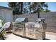 Outdoor kitchen featuring stainless steel grill, countertop, and pizza oven at 3759 E Charter Oak Rd, Phoenix, AZ 85032