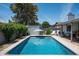 Stunning backyard pool surrounded by lush greenery, offering a private and refreshing oasis for relaxation at 3759 E Charter Oak Rd, Phoenix, AZ 85032