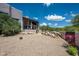 Charming backyard with desert landscaping, a covered patio, and gravel ground cover at 41503 N 109Th Pl, Scottsdale, AZ 85262